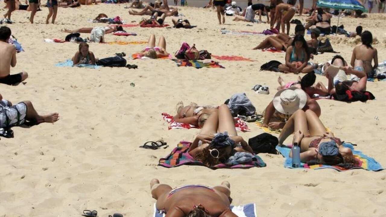 Beachgoers sunbathe at Bondi Beach in Sydney.