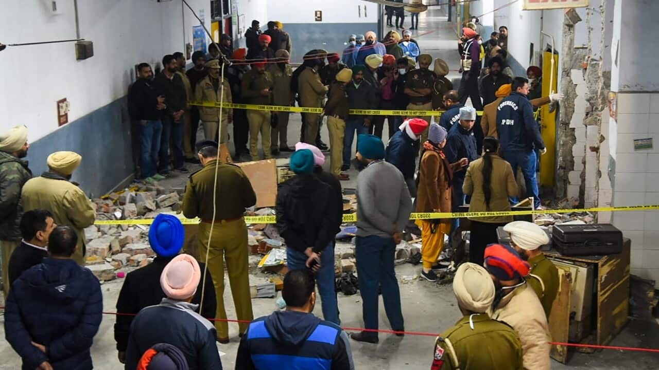 Police inspect the site of a blast, which reportedly killed at least one person and injured five, inside the court complex in Ludhiana, Punjab, on December 23.