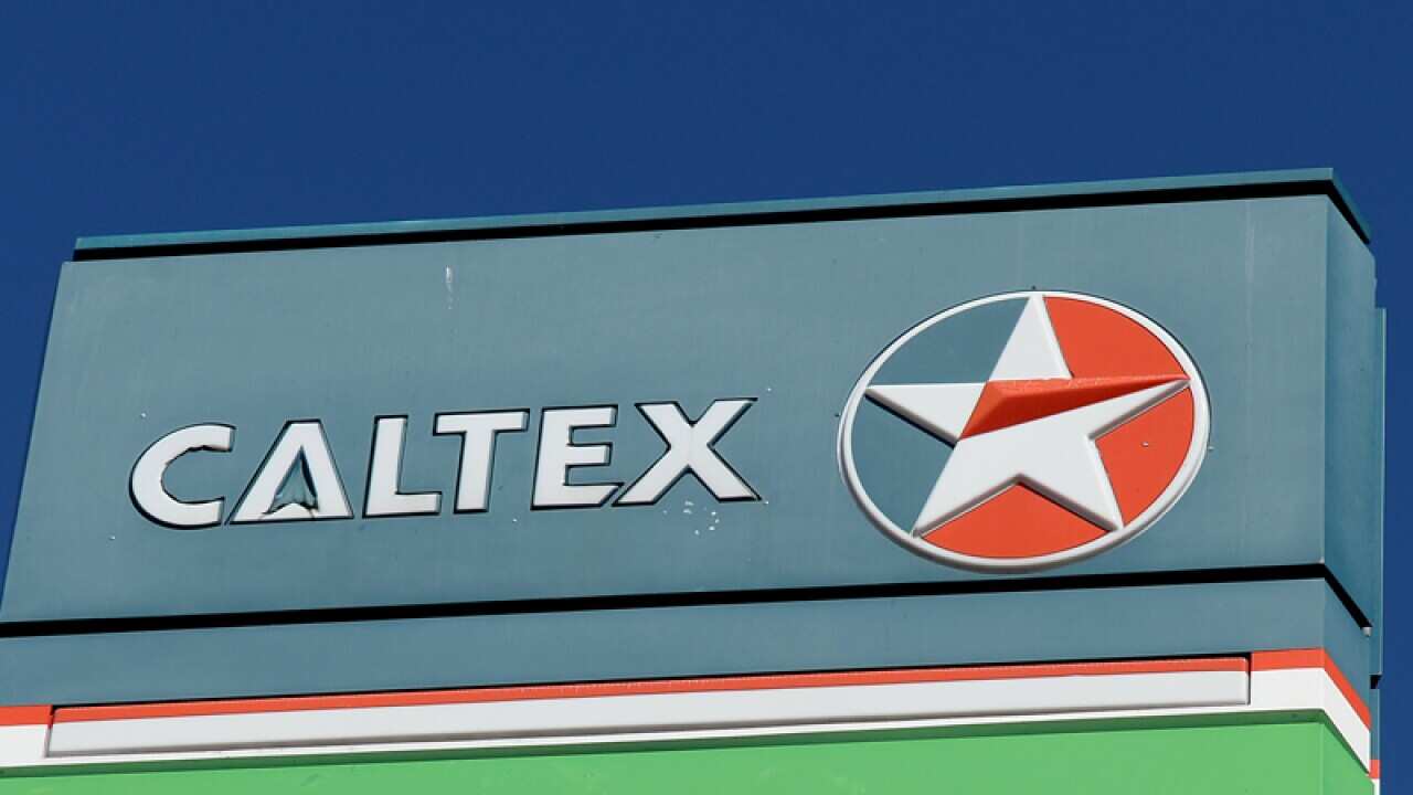 Signage displayed at a Woolworths service station.