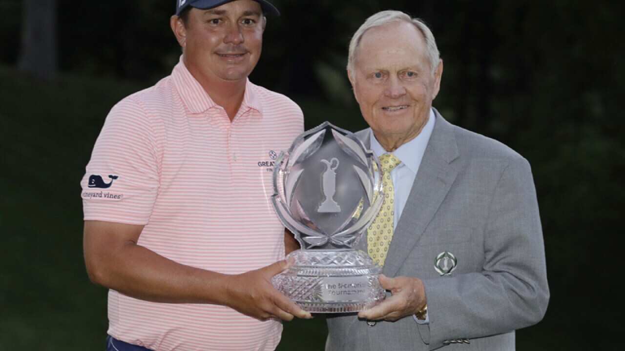 Jack Nicklaus (R) hands Jason Dufner the trophy in Dublin