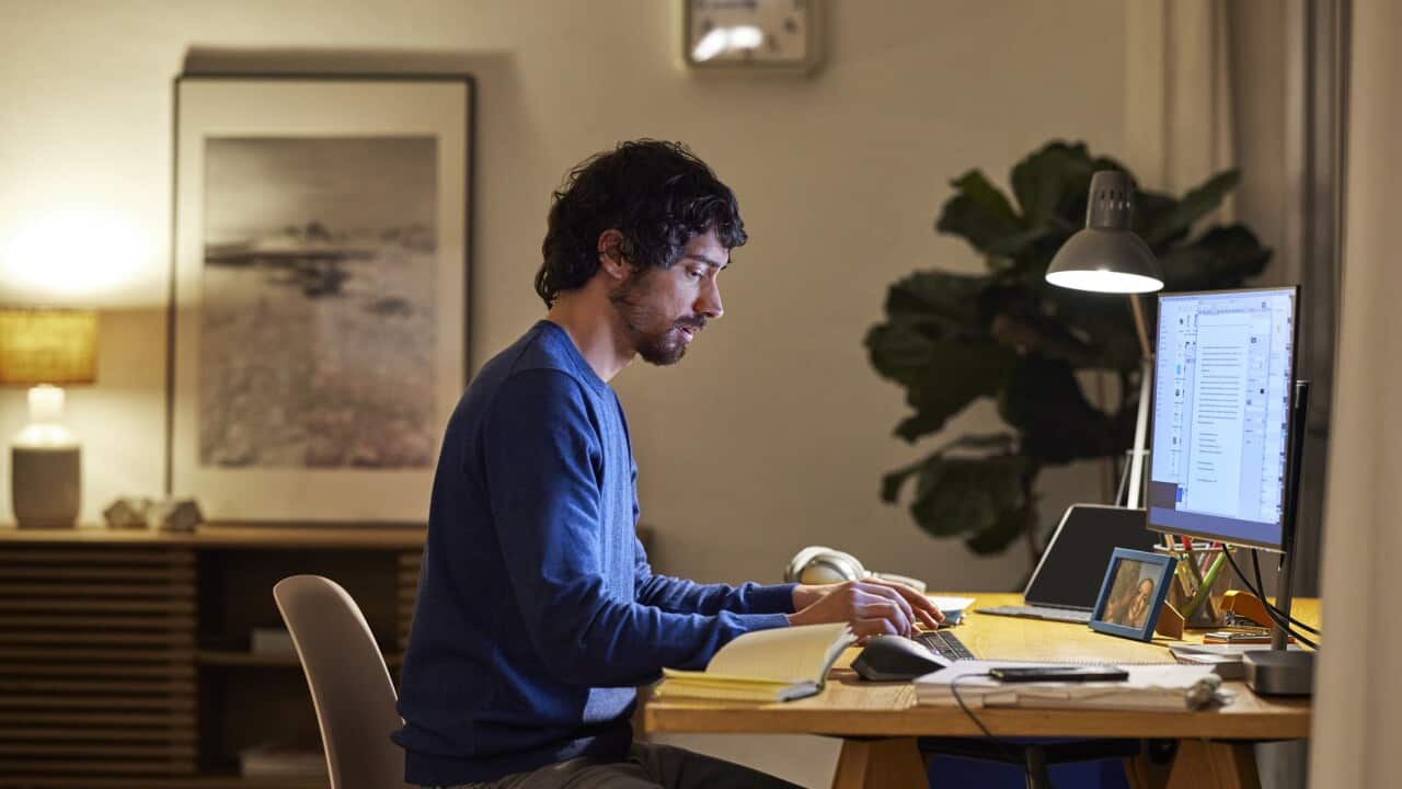 Male Entrepreneur Using Computer At Table