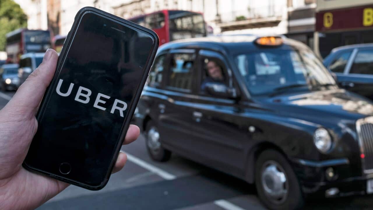An Uber app on a mobile phone in central London