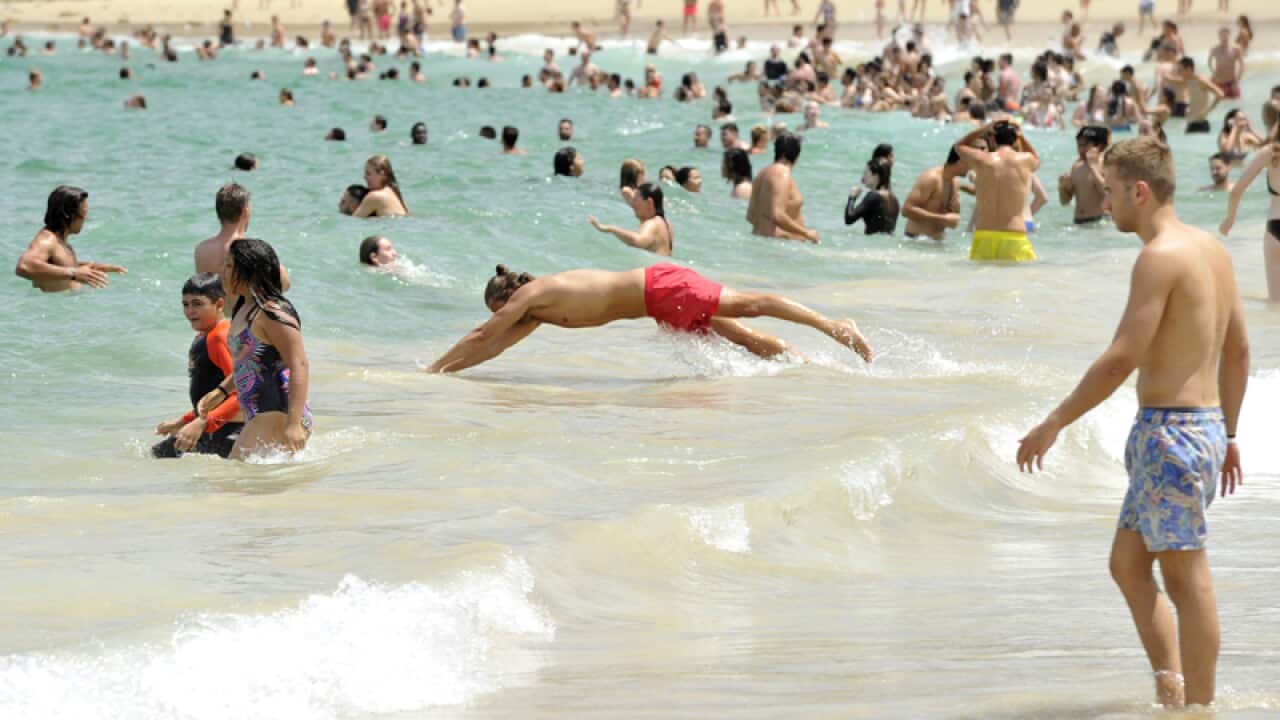 People enjoy the water at Coogee Beach