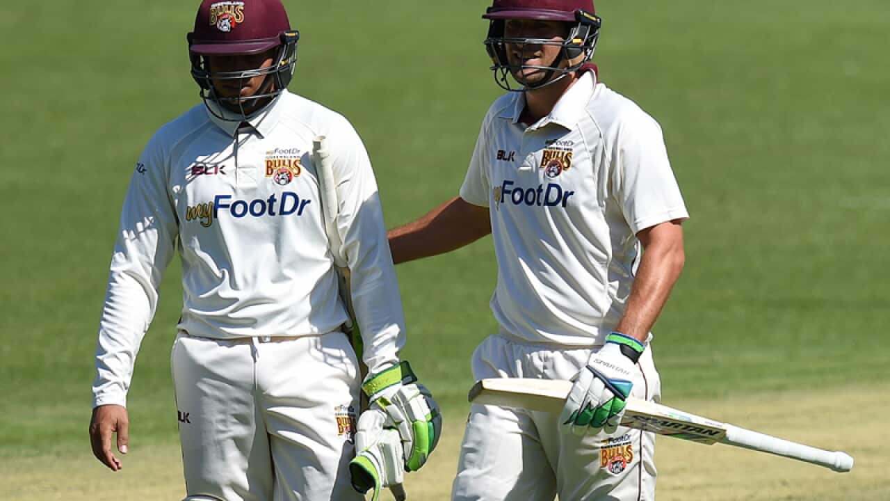 Queensland batsmen Usman Khawaja (L) and Joe Burns