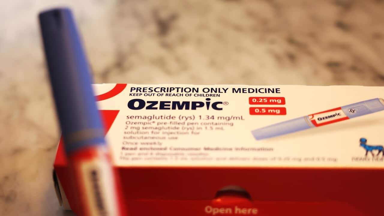 A medicine box with Ozempic written on it. A blue injector pen is in the foreground