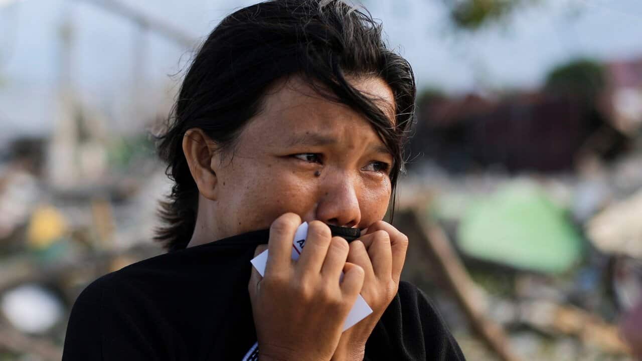 In this Oct. 5, 2018, file photo, Musrifah breaks into tears as she visits the area where her house used to stand before a massive earthquake and tsunami hit their seaside village in Palu, Central Sulawesi, Indonesia. (AP Photo/Aaron Favila)