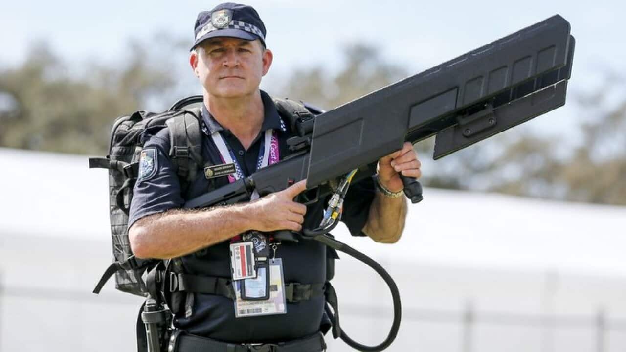 Sgt John Hildebrand holds a drone gun during the Queensland Police Service and The Australian Defence Force joint security display in Southport this morning