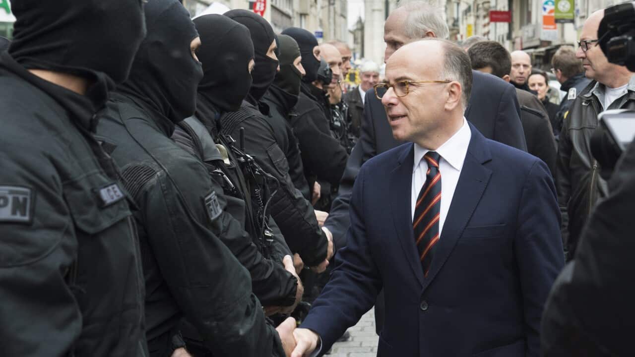 French Interior Minister Bernard Cazeneuve greeting police offciers during a police assault in Saint Denis, near Paris, France