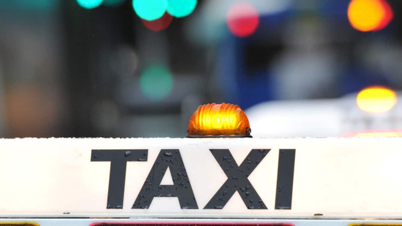 A taxi waits at a rank