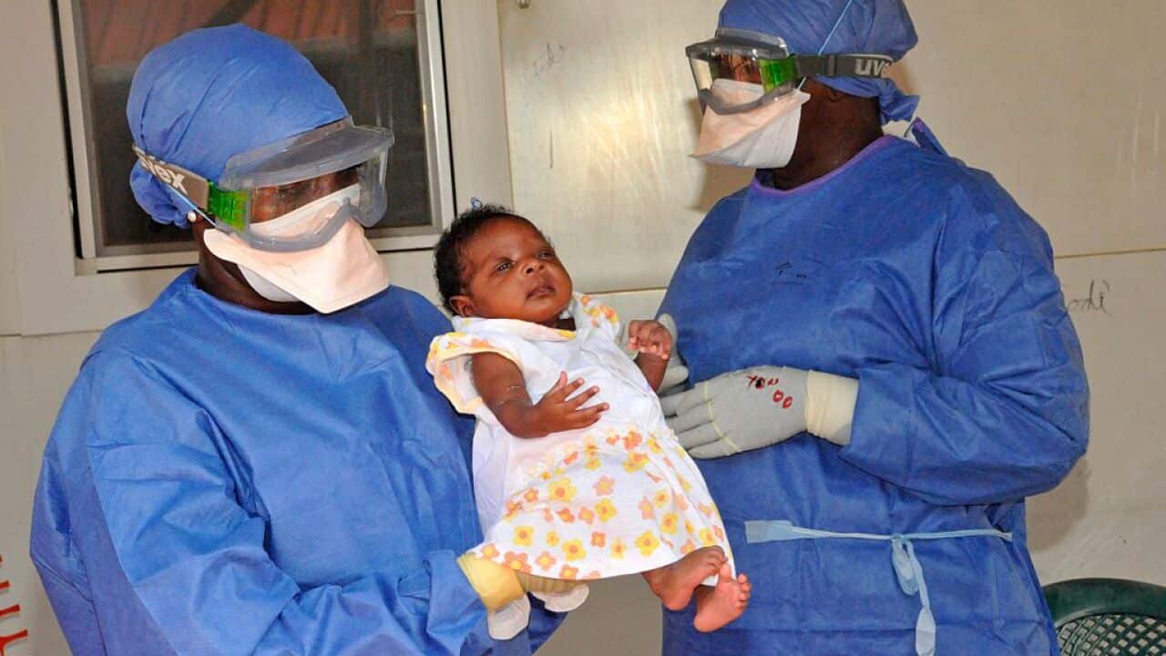 Medical workers present Noubia, the last known patient to contract Ebola in Guinea, during her release from a Doctors Without Borders treatment center in Conakry