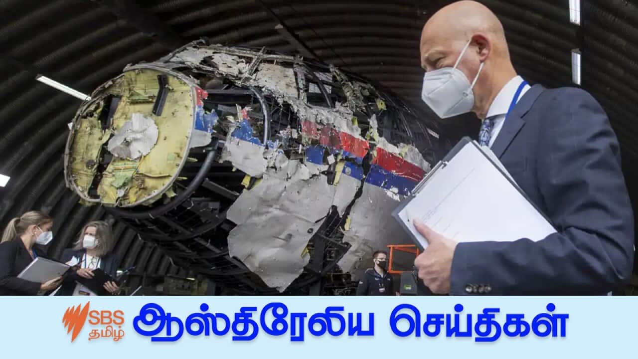 Presiding judge Hendrik Steenhuis (right) and other trial judges and lawyers viewing the reconstructed wreckage of Malaysia Airlines flight MH17 at the Gilze-Rijen military airbase in the Netherlands on 26 May, 2021