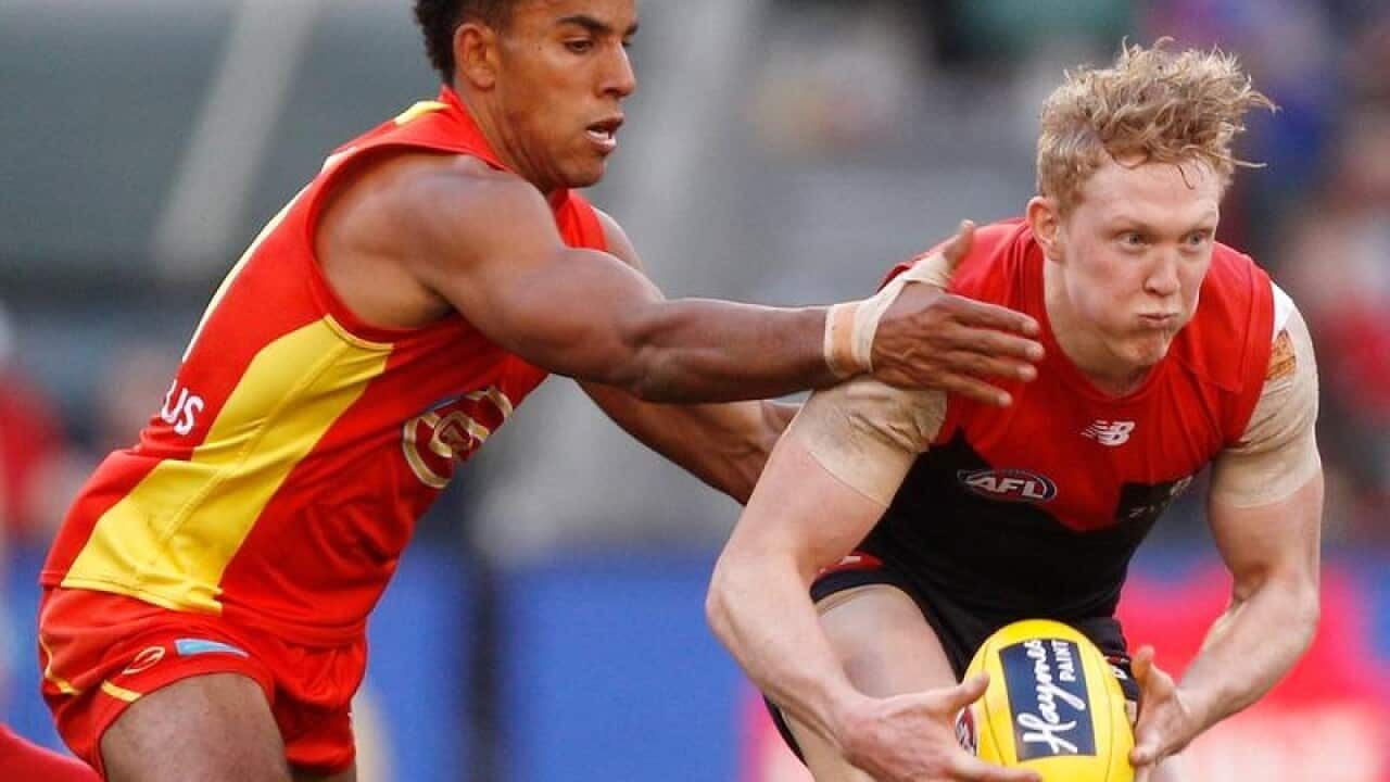 Gold Coast's Touk Miller and Clayton Oliver of Melkbourne