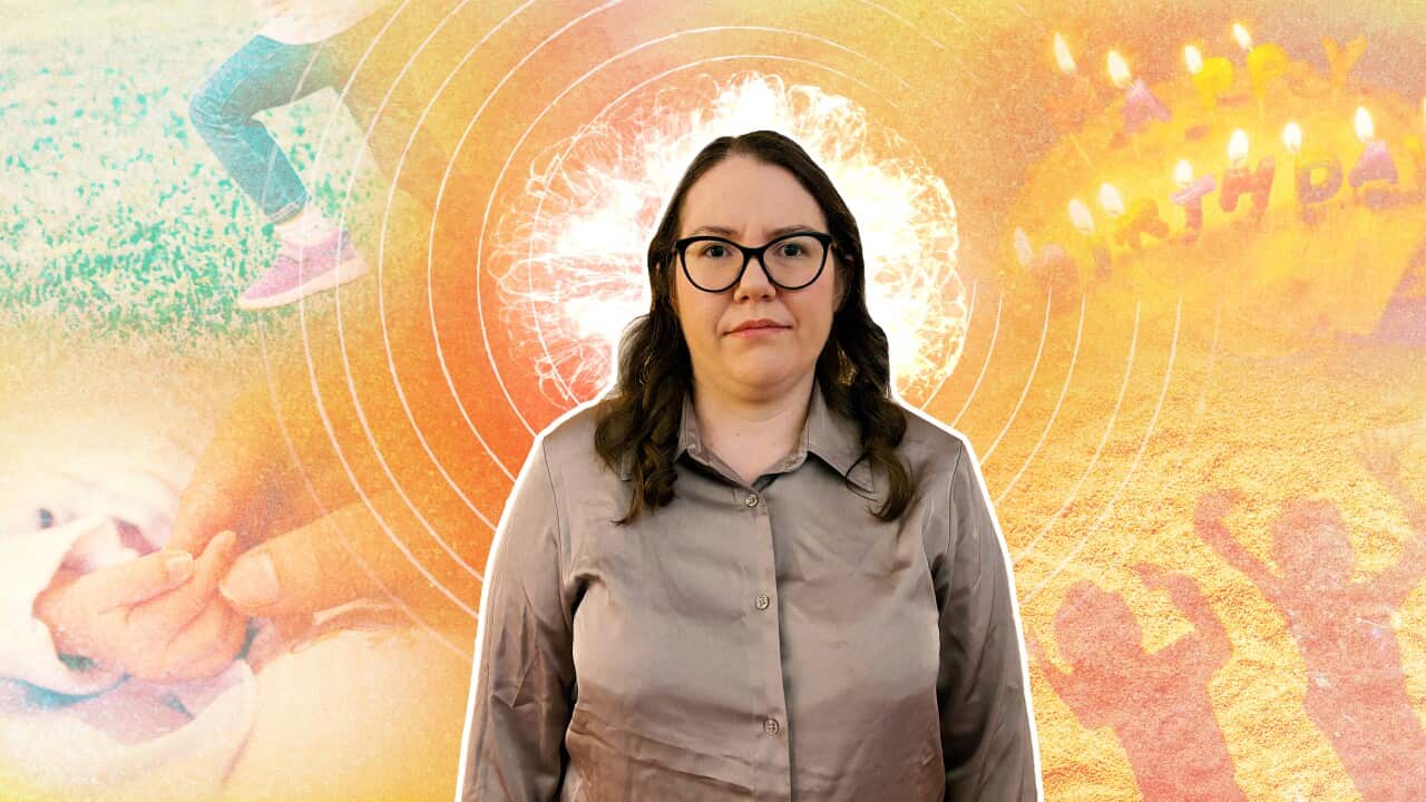 A woman wearing glasses and an olive-coloured shirt posing for a picture