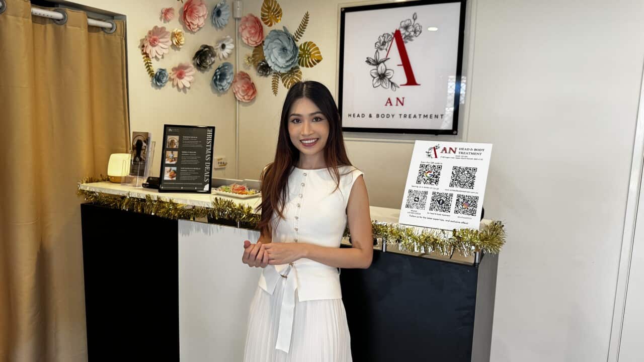 A woman in a white dress standing inside a wellness spa