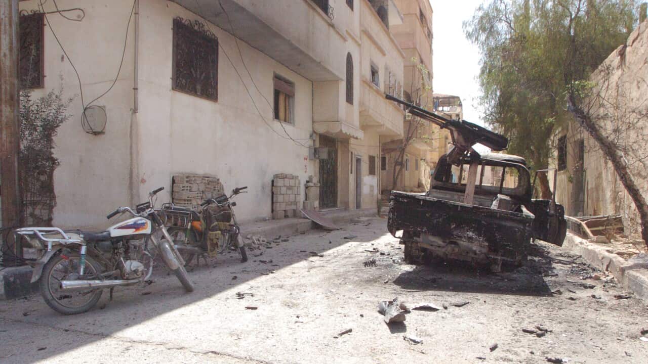 A torched machinegun-loaded vehicle is seen at one of the streets of the ancient city of Palmyra