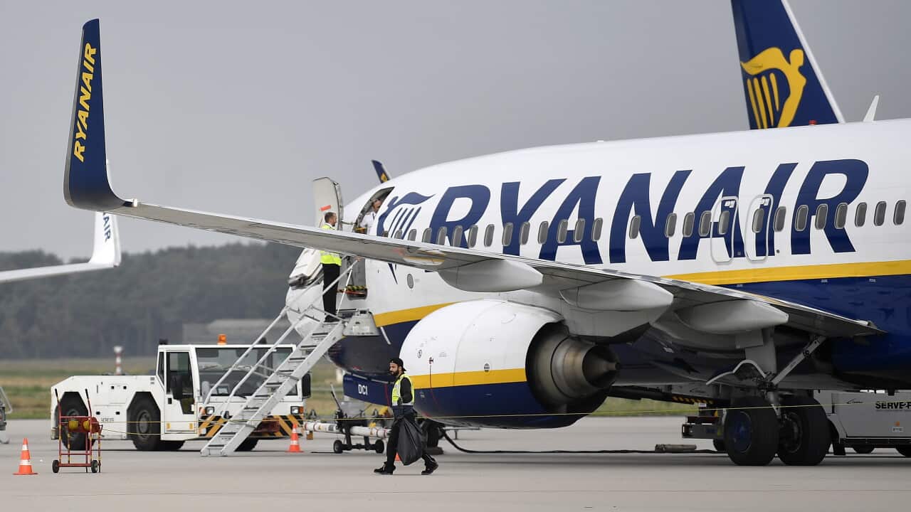 An aircraft with Ryanair branding on a tarmac.
