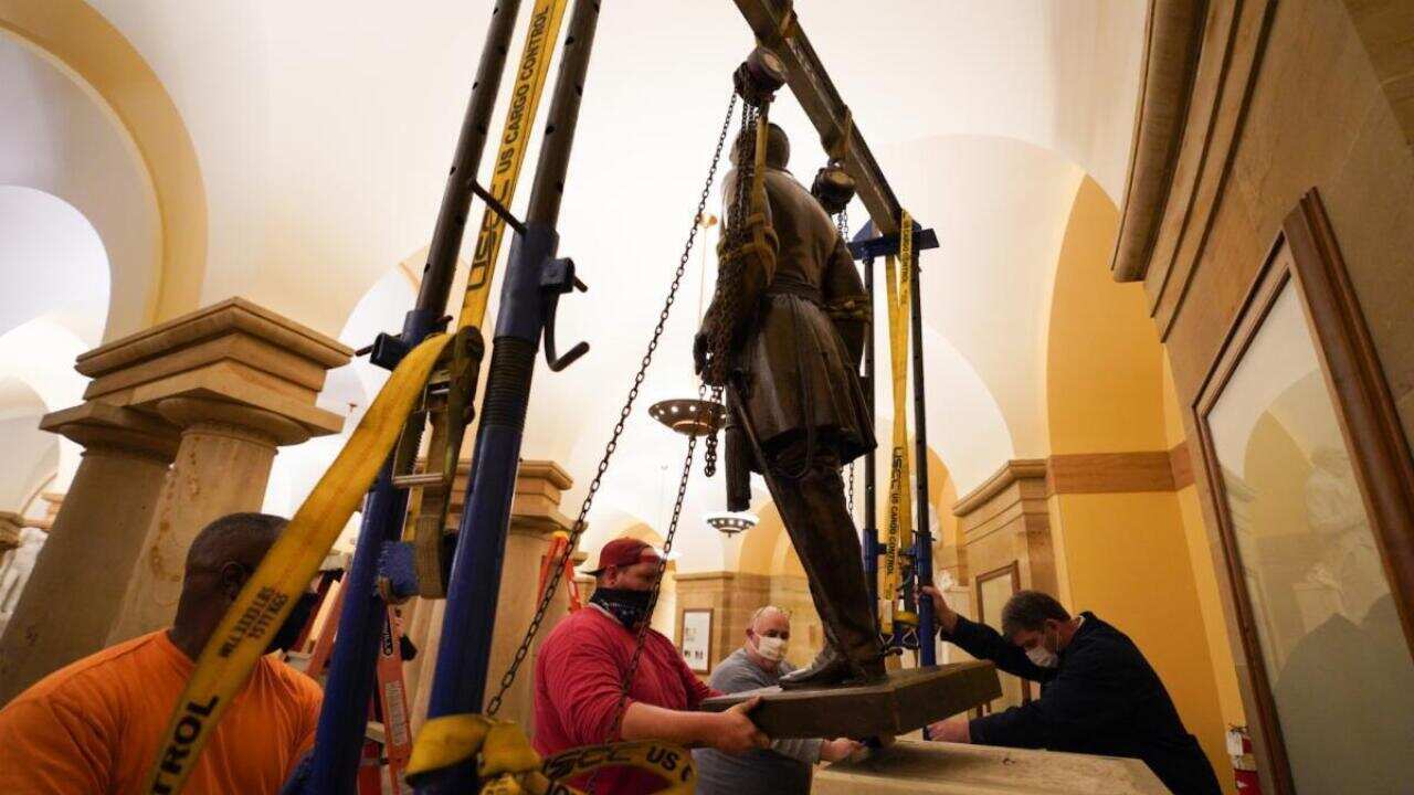 Workers remove a statue of Confederate General Robert E. Lee from the National Statuary Hall Collection in Washington.