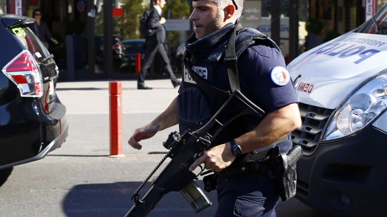 A police officer runs to take position during a bomb scare