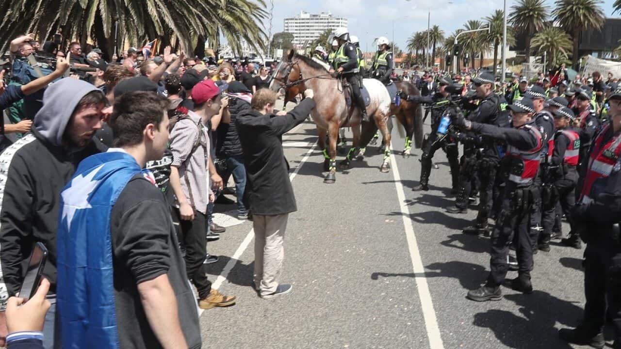 Police keep far-right nationalists apart from rival protesters in St Kilda.