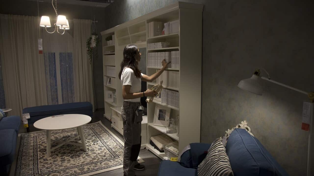 A staff member arranges items in India's first IKEA store ahead of its opening.