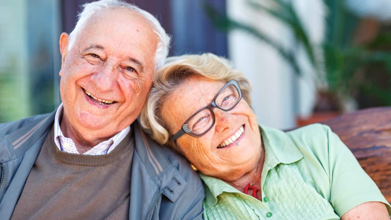 A senior couple is laughing.