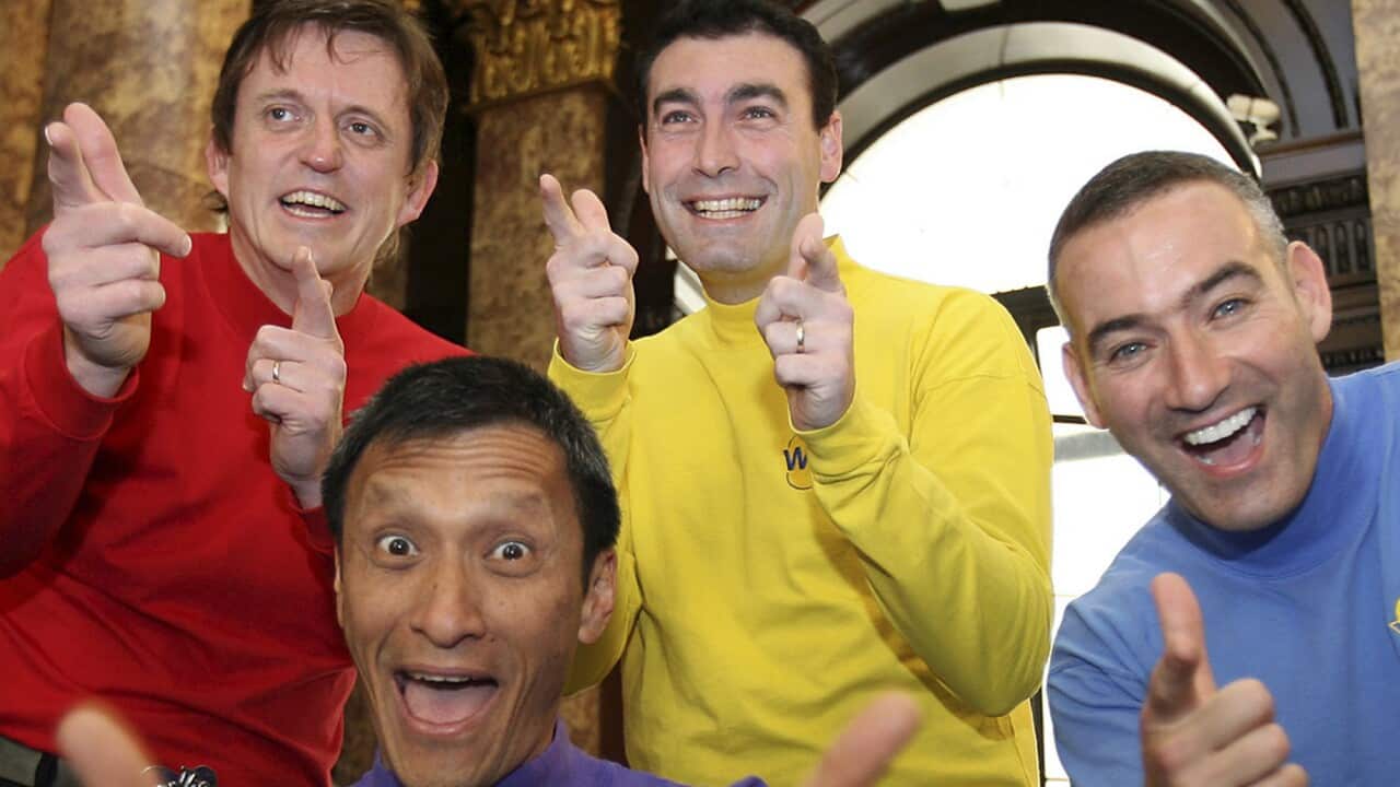 Men smiling and pointing their fingers.