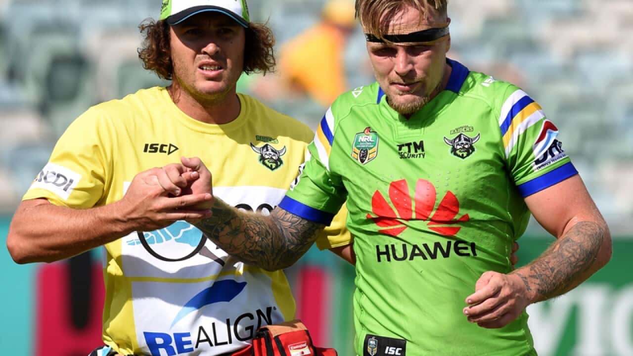 Blake Austin of the Raiders leaves the field with an injury