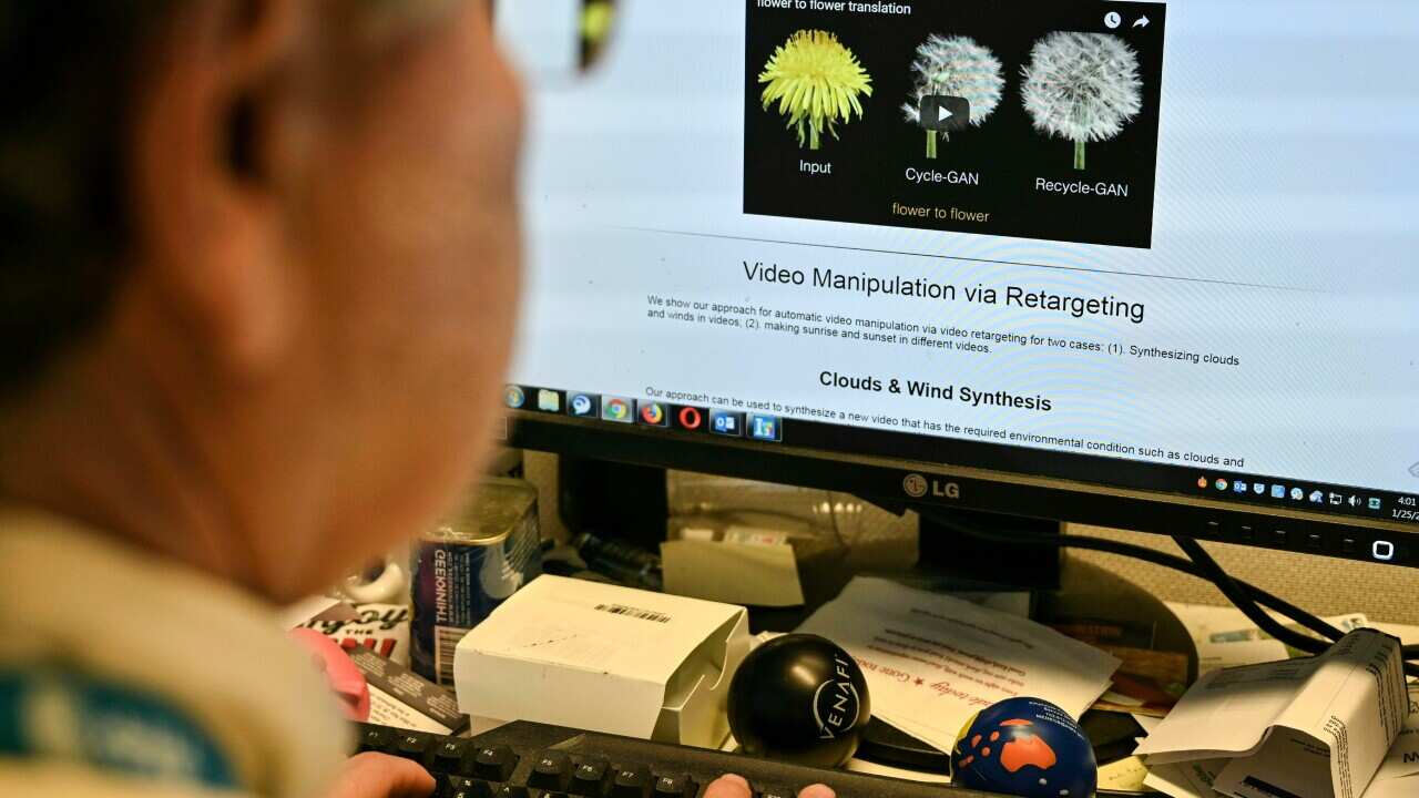 An AFP journalist views an example of a "deepfake" video manipulated using artificial intelligence