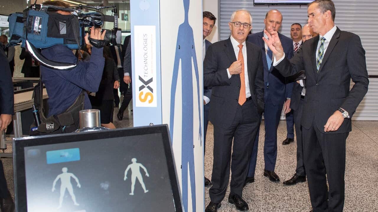 Australian Prime Minister Malcolm Turnbull and the Minister for Home Affairs Peter Dutton MP, are seen inspecting a body scanner