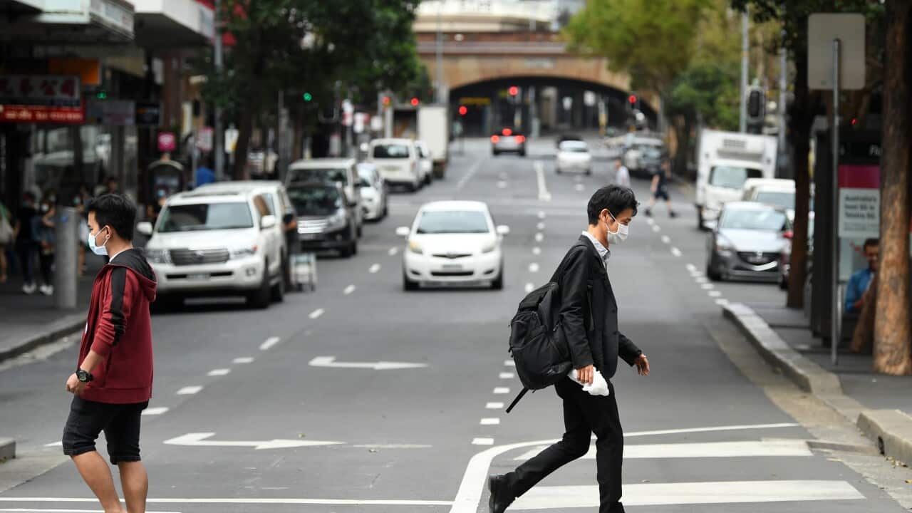 Pedestrians seen wearing a face mask in the CBD, Sydney, Thursday, March 26, 2020.