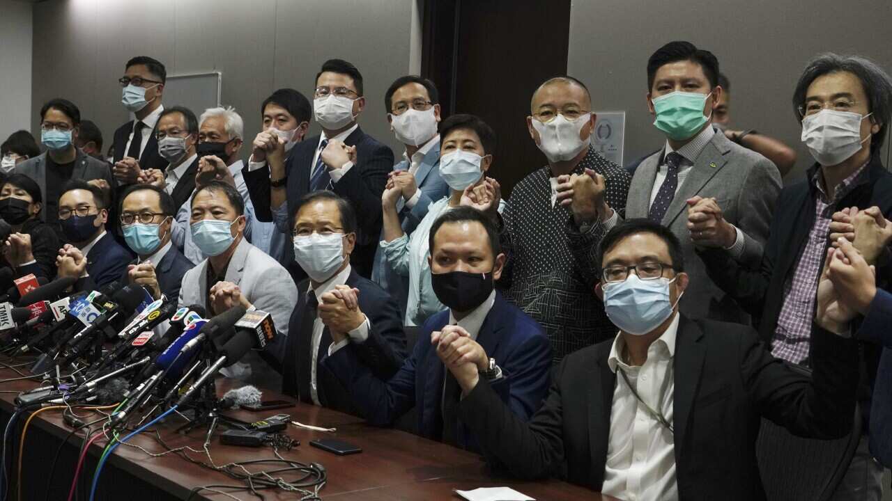 Pro-democracy legislators pose at the Legislative Council in Hong Kong, Wednesday, Nov. 11, 2020.