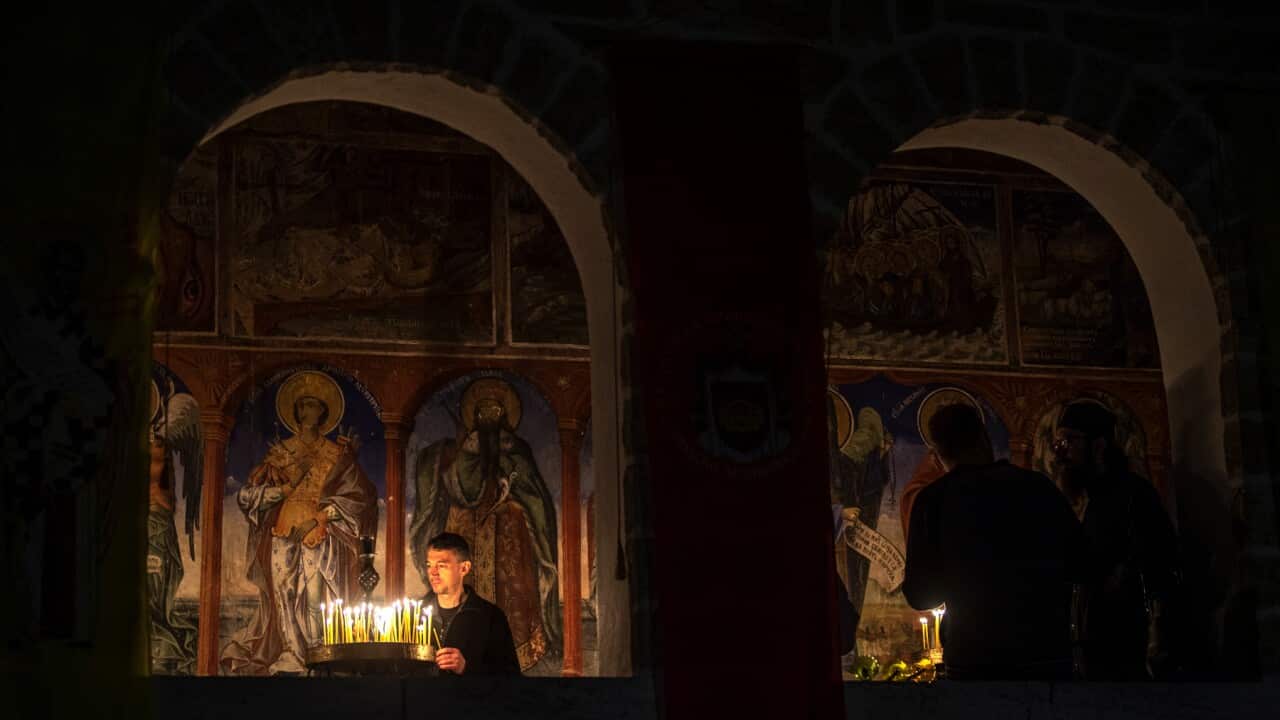 An orthodox pilgrim lights candles during the Orthodox Christian Easter service at the 10th century monastery of St. John the Baptist 'Sv. Jovan Bigorski' near Mavrovo, Republic of Macedonia