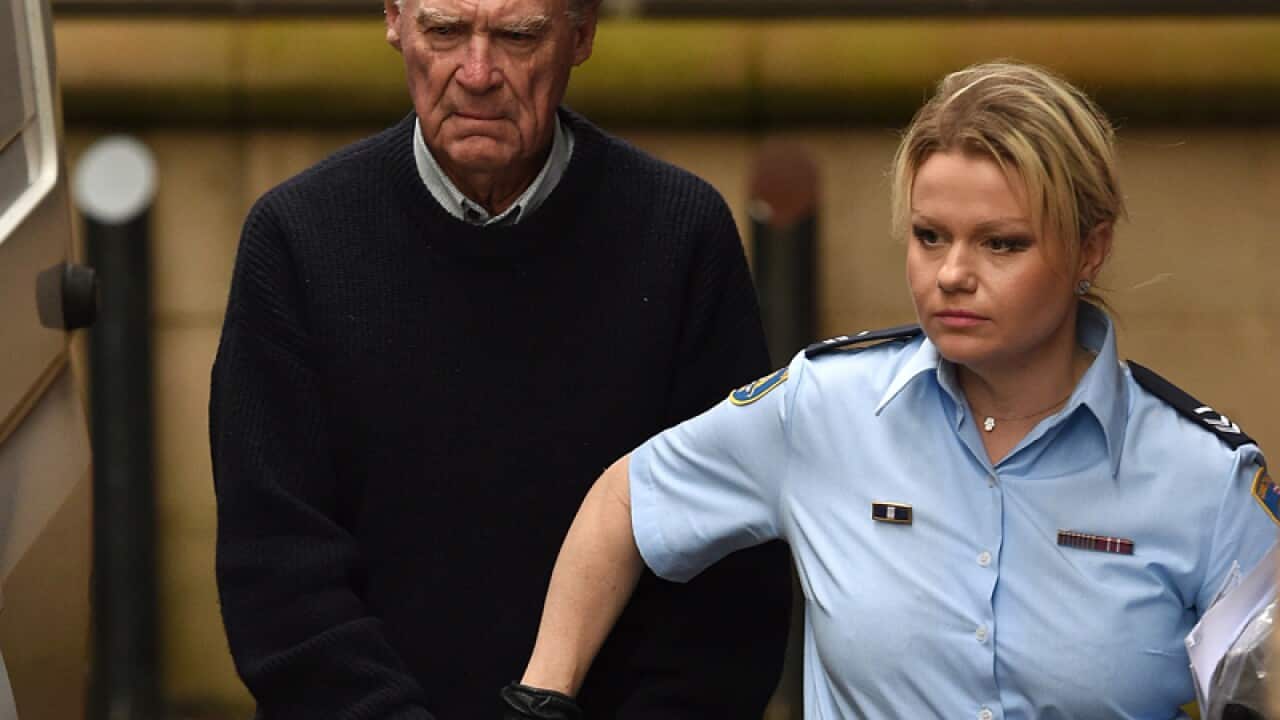 Ian Turnbull is escorted by Corrective Services officers