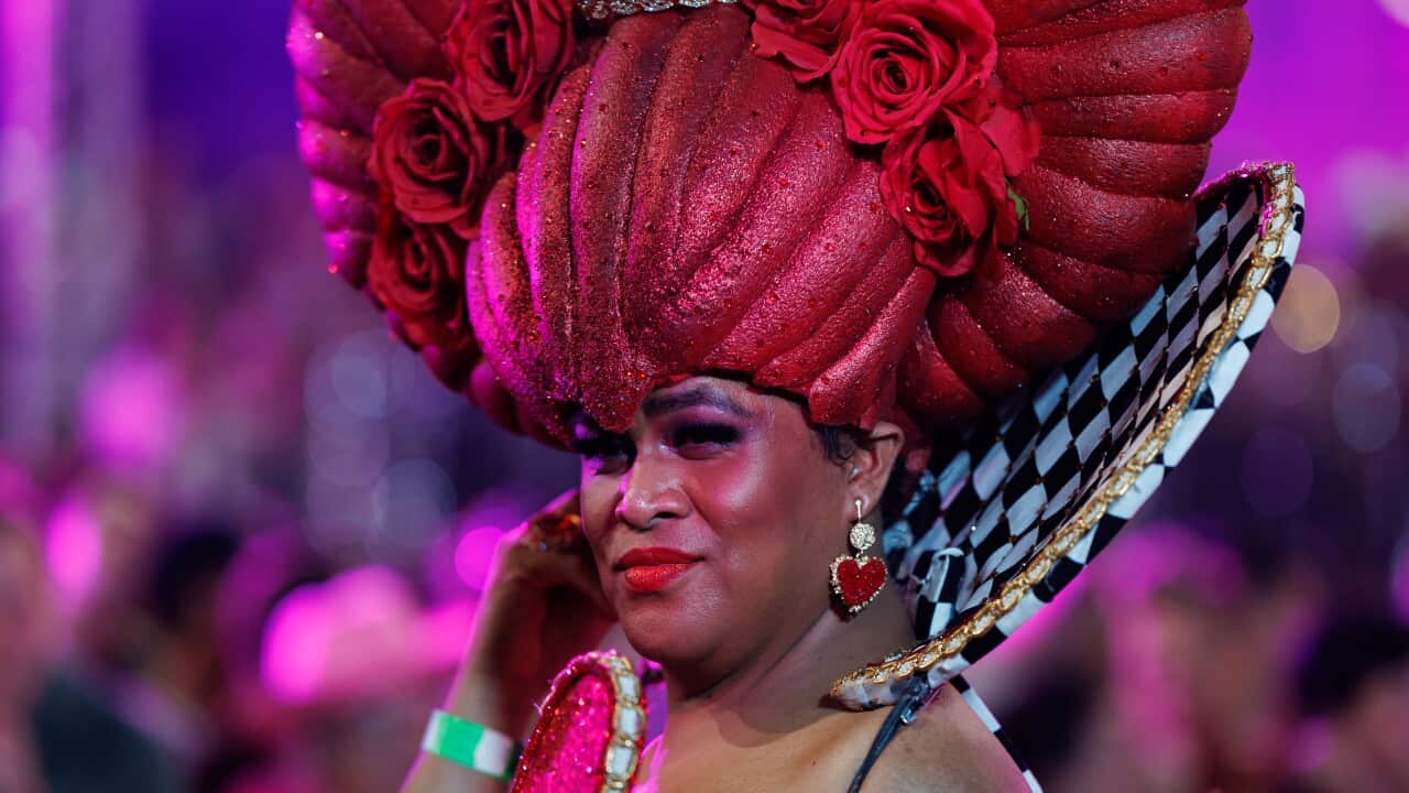 A drag queen wearing an ornate headdress poses for the camera at the annual Sydney Gay and Lesbian Mardi Gras parade