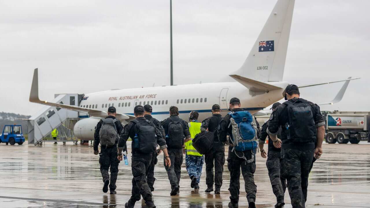 Australian Federal Police Special Operations members prepare to depart Canberra, for the Solomon Islands.