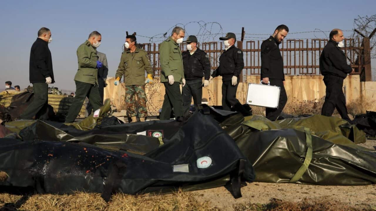 Security personnel work at the scene where a Ukrainian plane crashed in Shahedshahr, southwest of the capital Tehran, Iran