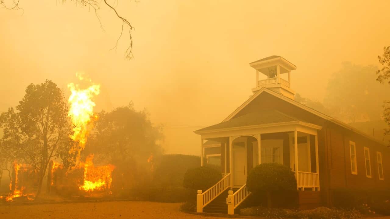 Flames from a propane tank rise as smoke from a wildfire blankets the area on Monday, Oct. 9, 2017, in Napa, Calif.