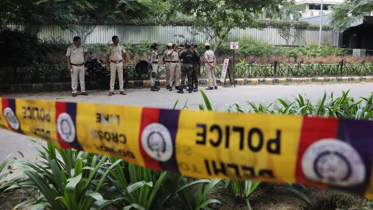 Indian policemen secure the premises around the Canadian embassy in New Delhi, India amid protests.jpg