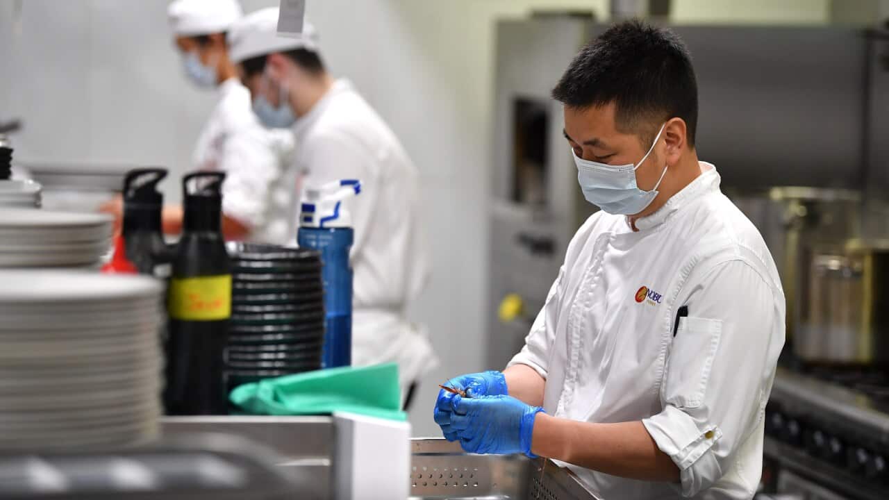 Workers prepare food at Japanese restaurant Nobu at Crown Sydney in Sydney, Sunday, October 10, 2021. From Monday, lockdown restrictions will lift for fully vaccinated people across NSW. (AAP Image/Joel Carrett) NO ARCHIVING