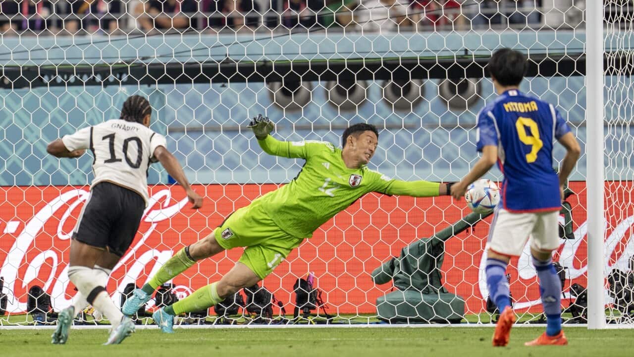 Japan's Shuichi Gonda saves another shot at goal from Germany