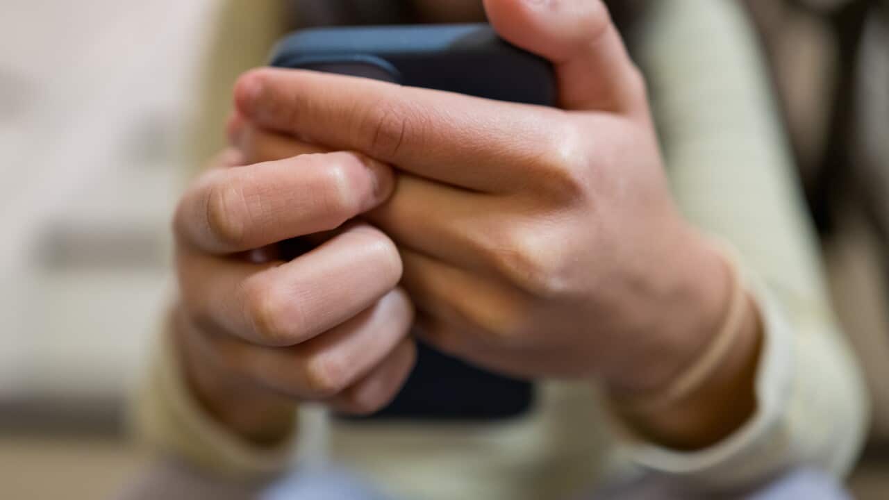 A close-up of a woman's hands holding a smartphone.