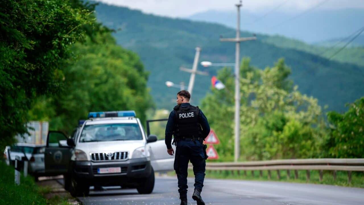 A member of the Kosovo Police Special Unit secures the area near the village of Cabra, near the town of Mitrovica.