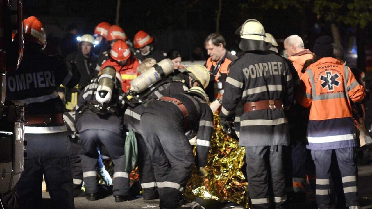 Romanian fire workers and paramedics are trying to rescue a survivor