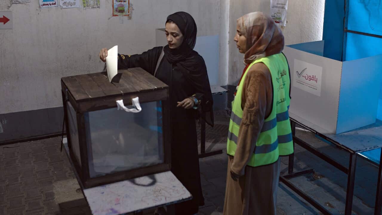 A woman casts her vote in the municipal elections in Deir al-Balah, in the central Gaza Strip.