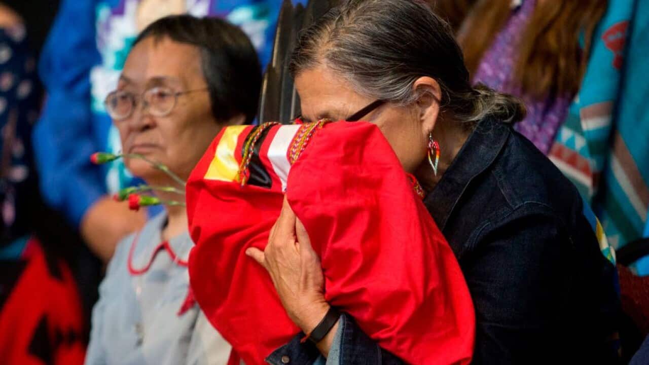 An elder indigenous women embraces the final copy of the National Inquiry into Missing and Murdered Indigenous Women and Girls (Getty Images)