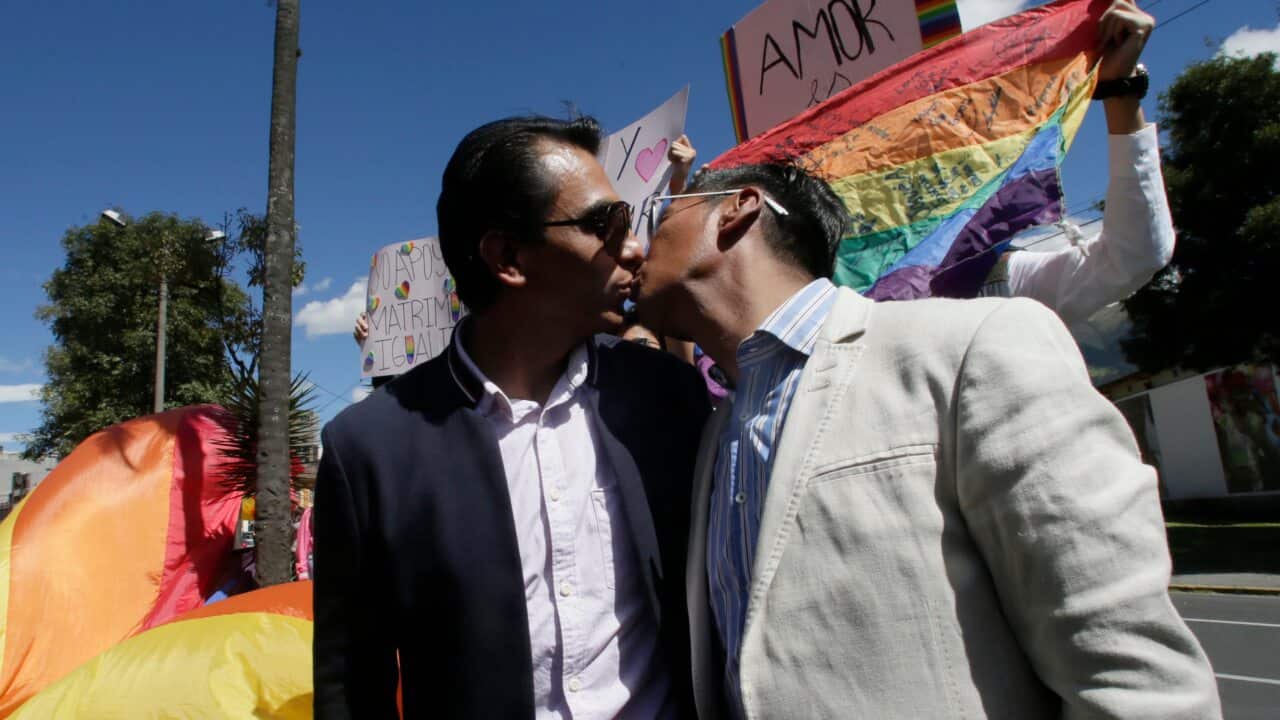 Javier Benalcazar, left, and his partner Efrain Soria kiss as they arrive to to know the final decision of the Constitutional Court.