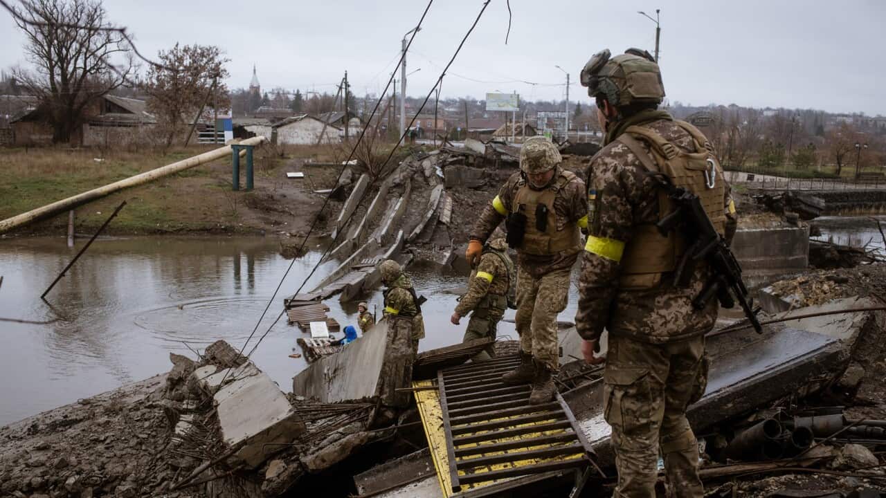 Ukrainians soldiers try to improve a pontoon bridge in Bakhmut, under daily Russian shelling