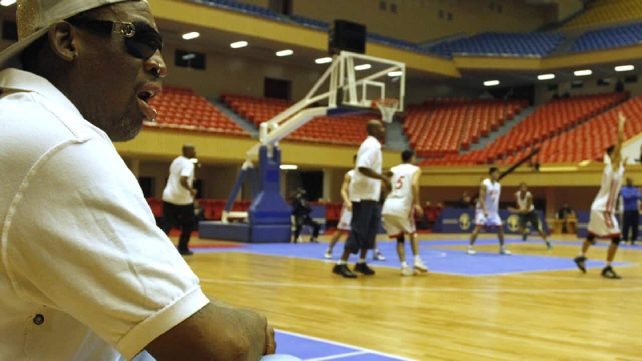 Dennis Rodman watching an exhibition game in North Korea