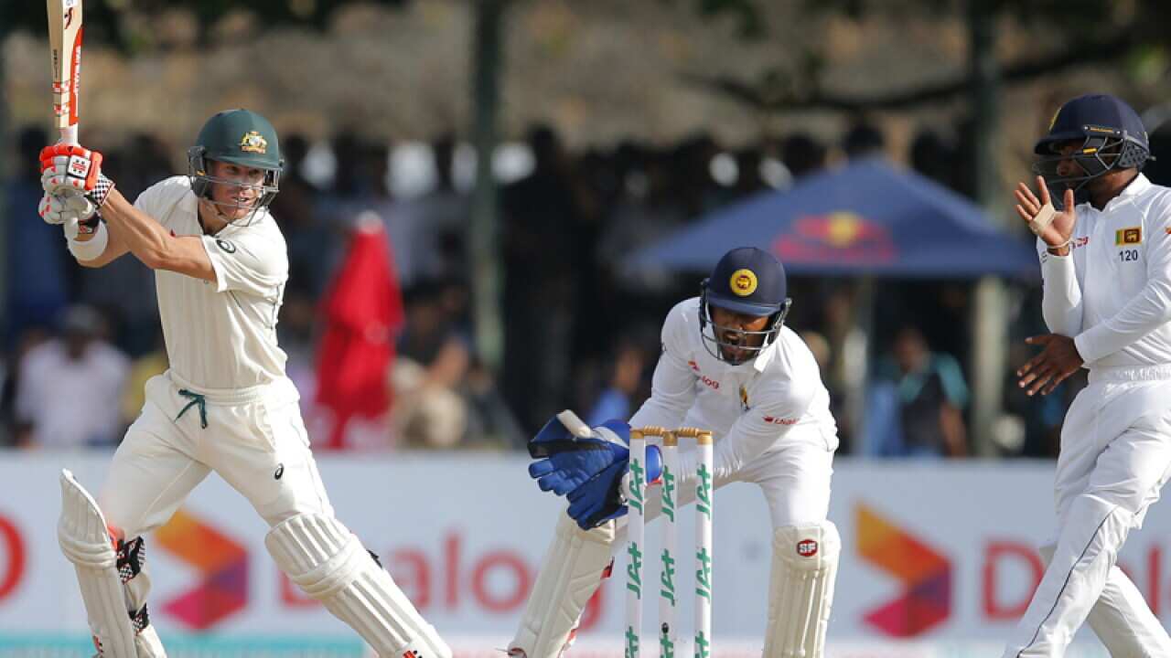 Australian batsmen David Warner plays a shot