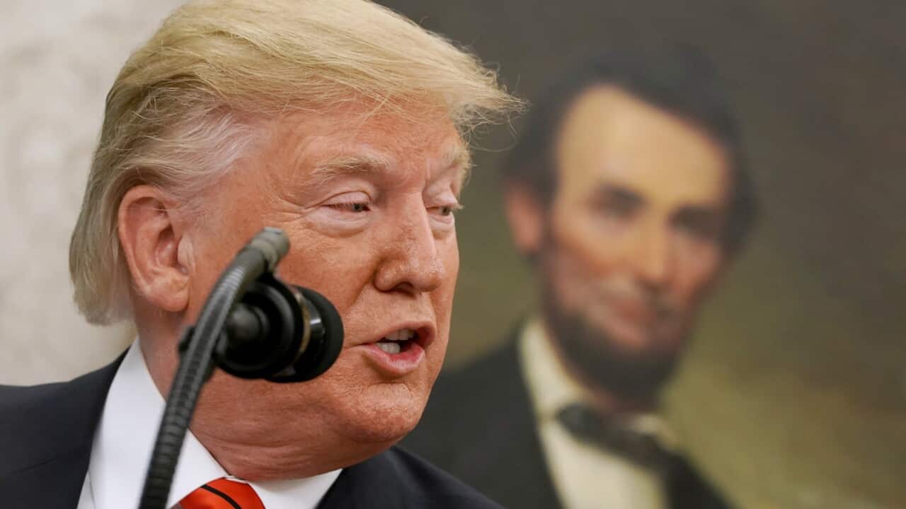 Donald Trump in the Oval Office, with President Abraham Lincoln's portrait behind him